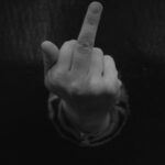 a person pointing a finger at the camera