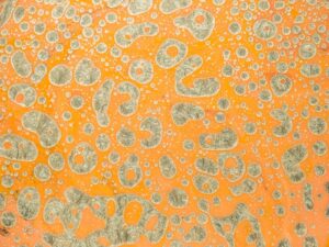 A vibrant abstract image featuring a textured pattern with orange and gray hues.